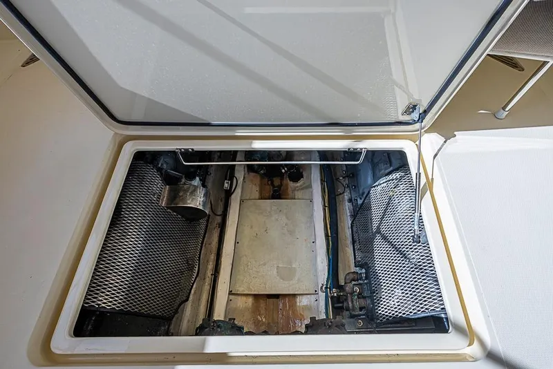 Slide: The Image of Open engine compartment of 2002 Hinckley Talaria 40 boat, showcasing internal components. - 15