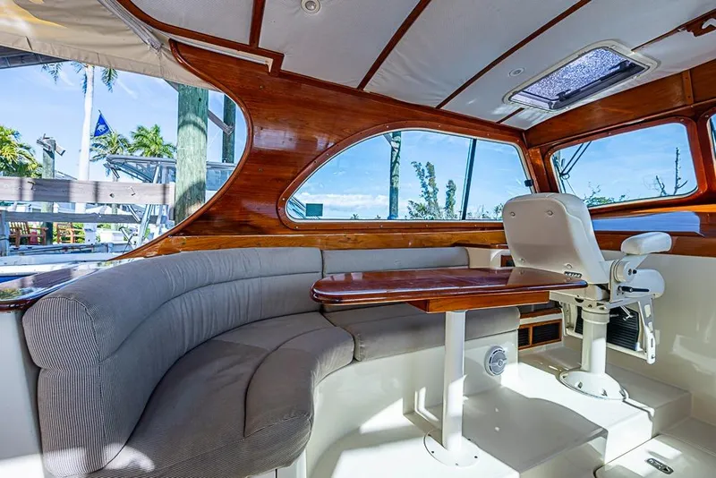 Slide: The Image of Interior of 2002 Hinckley Talaria 40 yacht with elegant wood finish and plush seating. - 4