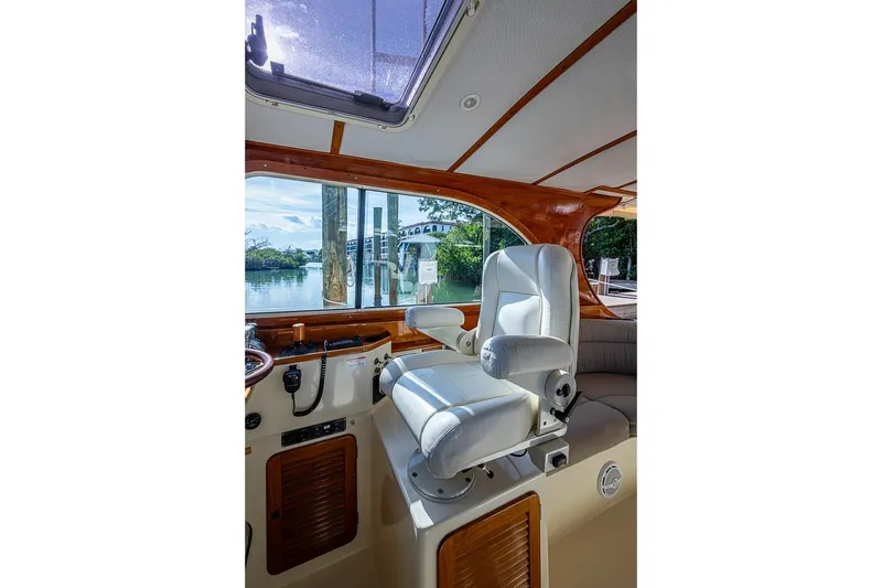 Slide: The Image of Interior of 2002 Hinckley Talaria 40 yacht with white captain's chair and scenic window view. - 6