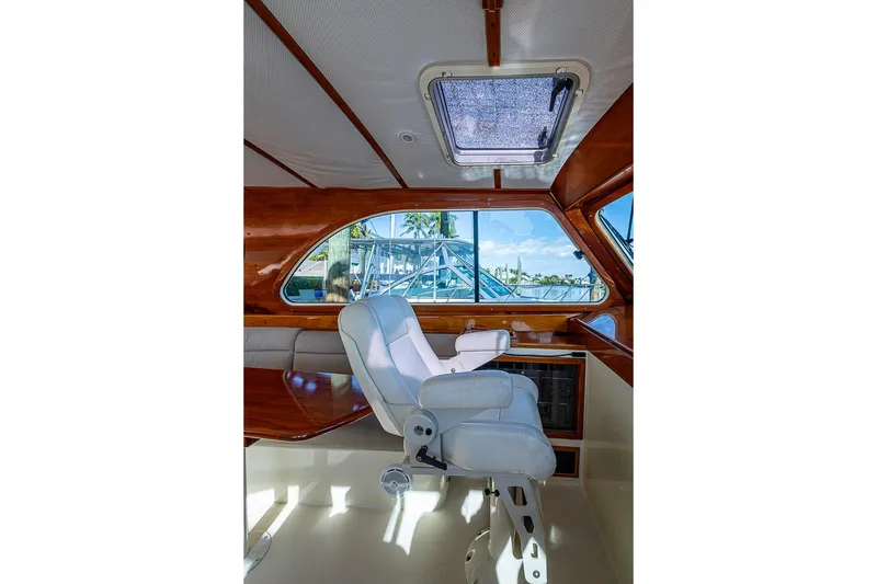Slide: The Image of Interior of 2002 Hinckley Talaria 40 yacht with white captain's chair and wooden accents. - 7