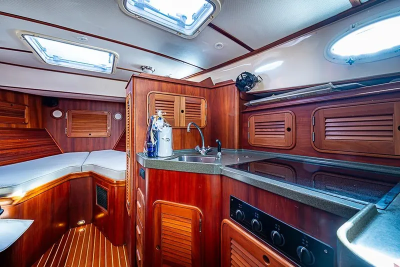 Slide: The Image of Luxurious 2002 Hinckley Talaria 40 yacht interior with wood finish and modern amenities. - 10