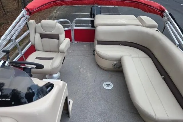 Slide: The Image of 2017 Sun Tracker Party Barge 20 DLX interior with beige seating and red canopy. - 3