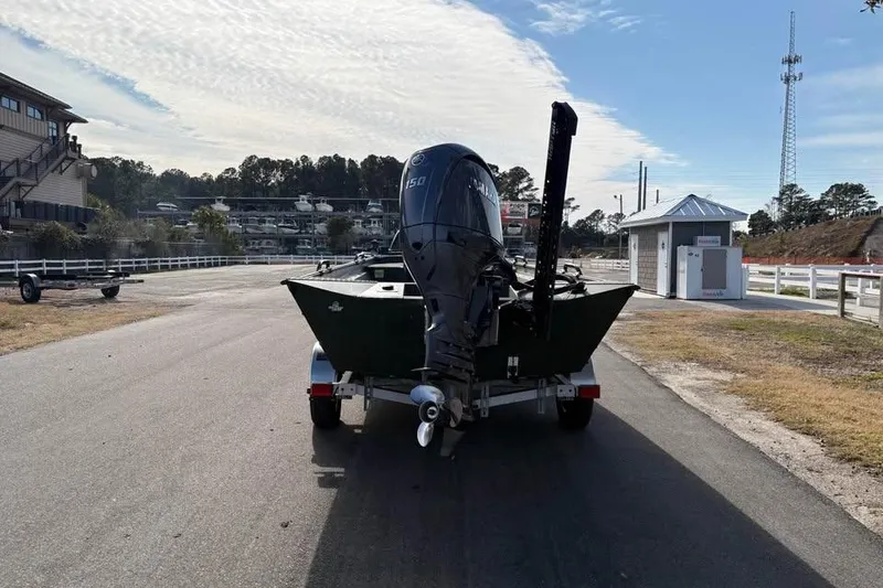 Slide: The Image of 2025 Alweld 2070VVCC Bay Boat on trailer, parked near marina under cloudy sky. - 3