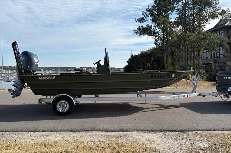 Slide: The Image of 2025 Alweld 2070VVCC Bay Boat on trailer, parked near waterfront. - 4