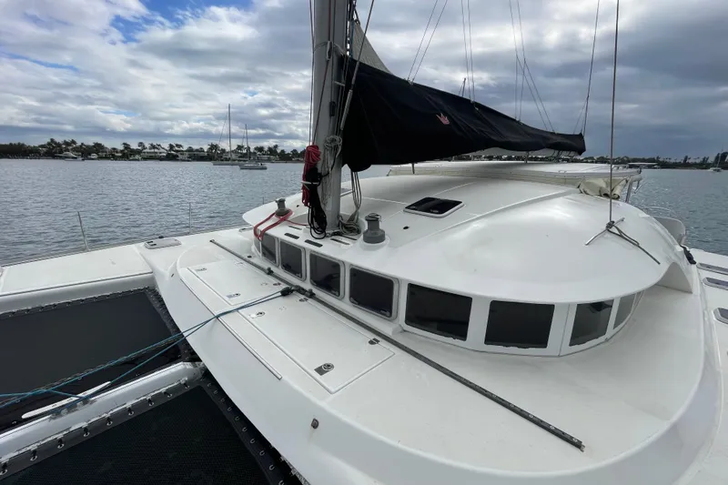Slide: The Image of 2004 Lagoon 570 catamaran on calm waters under cloudy skies. - 10