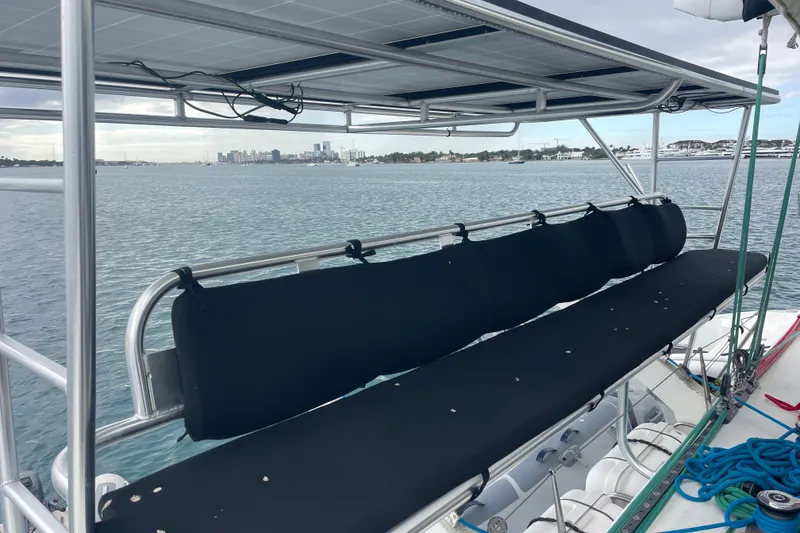 Slide: The Image of Lagoon 570 catamaran deck with seating, overlooking a calm waterfront view. - 19