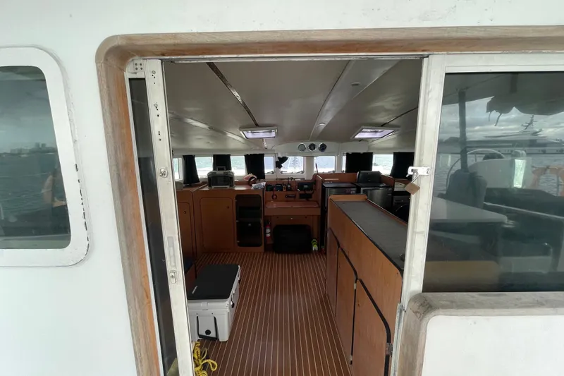 Slide: The Image of Interior view of 2004 Lagoon 570 yacht, featuring wooden cabinetry and nautical equipment. - 23