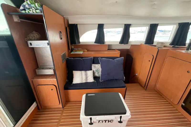 Slide: The Image of Cozy interior of 2004 Lagoon 570 yacht with wooden finish and comfortable seating. - 24