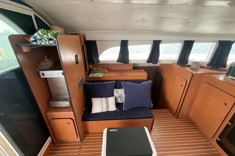 Slide: The Image of Interior of 2004 Lagoon 570 yacht with wooden cabinetry and cozy seating area. - 25