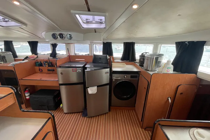 Slide: The Image of Interior of 2004 Lagoon 570 yacht with kitchen appliances and wooden cabinetry. - 31