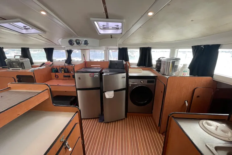 Slide: The Image of Interior of 2004 Lagoon 570 yacht with kitchen appliances and wooden cabinetry. - 33