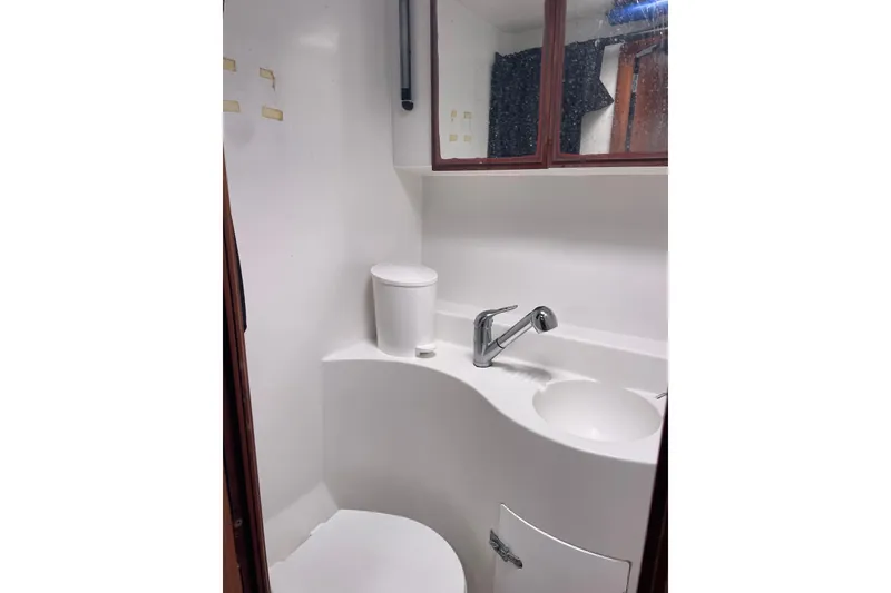 Slide: The Image of Bathroom interior of 2004 Lagoon 570 yacht with sink and mirror cabinet. - 38