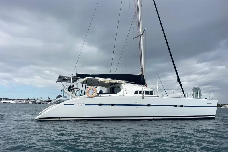 Slide: The Image of 2004 Lagoon 570 catamaran sailing on calm waters under cloudy skies. - 4