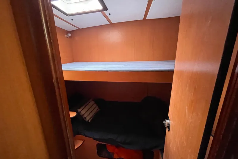 Slide: The Image of Interior cabin of 2004 Lagoon 570 yacht with bunk beds and wooden finish. - 43