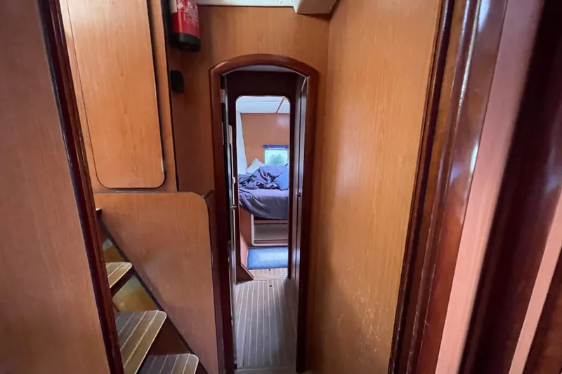 Slide: The Image of Interior view of 2004 Lagoon 570 yacht, featuring wooden hallway and cozy cabin. - 46