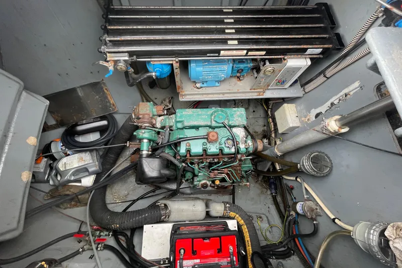 Slide: The Image of Engine compartment of a 2004 Lagoon 570 yacht, featuring mechanical components and wiring. - 59