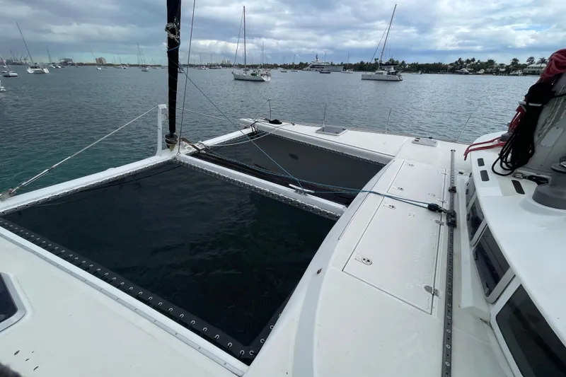 Slide: The Image of 2004 Lagoon 570 catamaran on calm waters with other boats in the background. - 8
