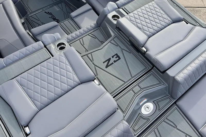 Slide: The Image of 2026 Tigé Z3 boat interior with gray quilted seats and cup holders. - 10