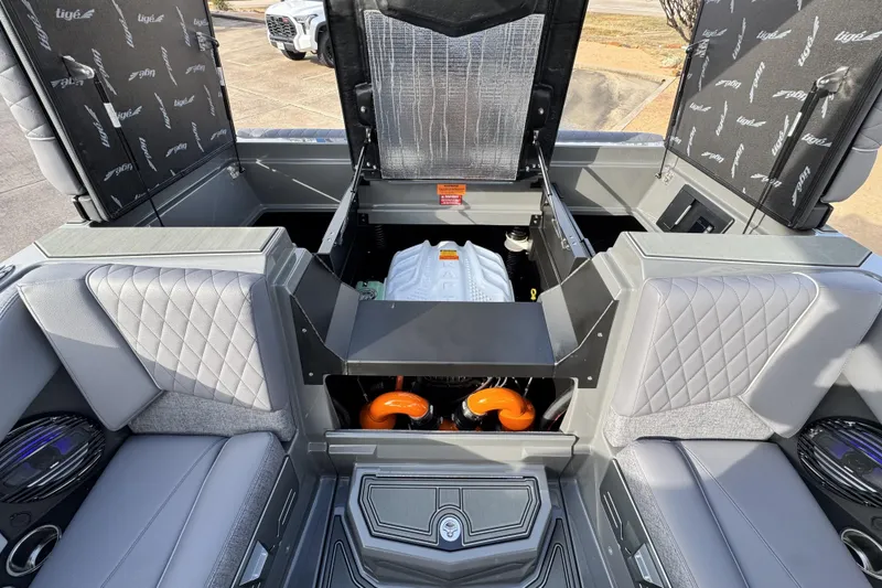 Slide: The Image of 2026 Tigé Z3 boat engine compartment with open hatches and quilted seating. - 21
