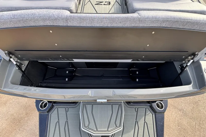 Slide: The Image of 2026 Tigé Z3 boat storage compartment with open lid, showcasing spacious interior design. - 24