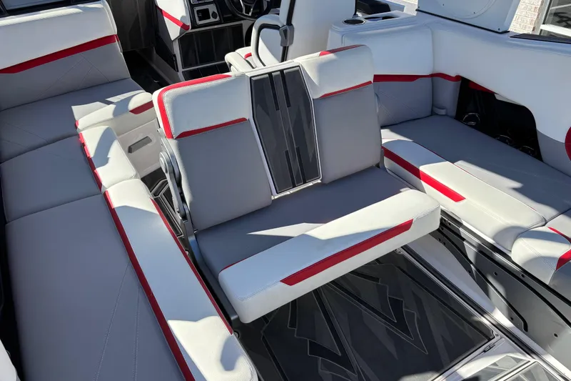 Slide: The Image of 2022 Supra SL 400 boat interior with gray and red seating, modern design. - 10