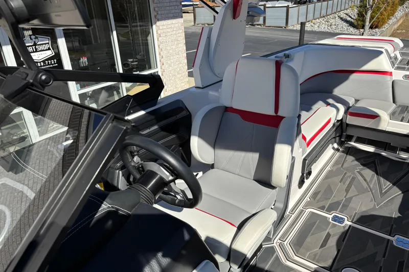 Slide: The Image of 2022 Supra SL 400 boat interior with steering wheel and seating, featuring modern design elements. - 12