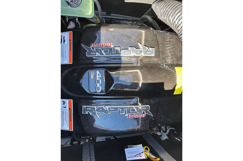 Slide: The Image of Engine cover of a 2022 Supra SL 400 with Raptor Indmar branding. - 13