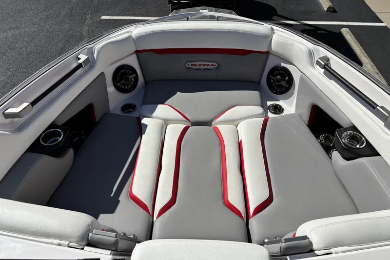 Slide: The Image of 2022 Supra SL 400 boat interior with gray and red seating, cup holders, and speakers. - 7
