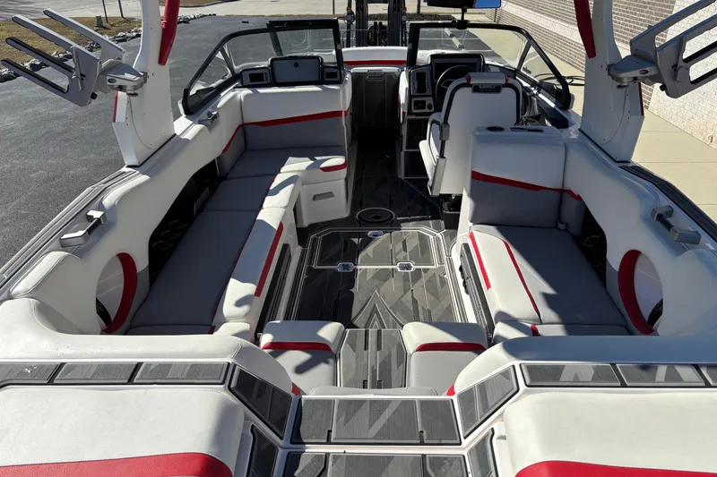 Slide: The Image of 2022 Supra SL 400 boat interior with red and gray seating, modern dashboard. - 8