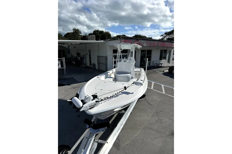 Slide: The Image of 2024 Contender 25 Bay boat with Yamaha outboard engine on a trailer. - 2