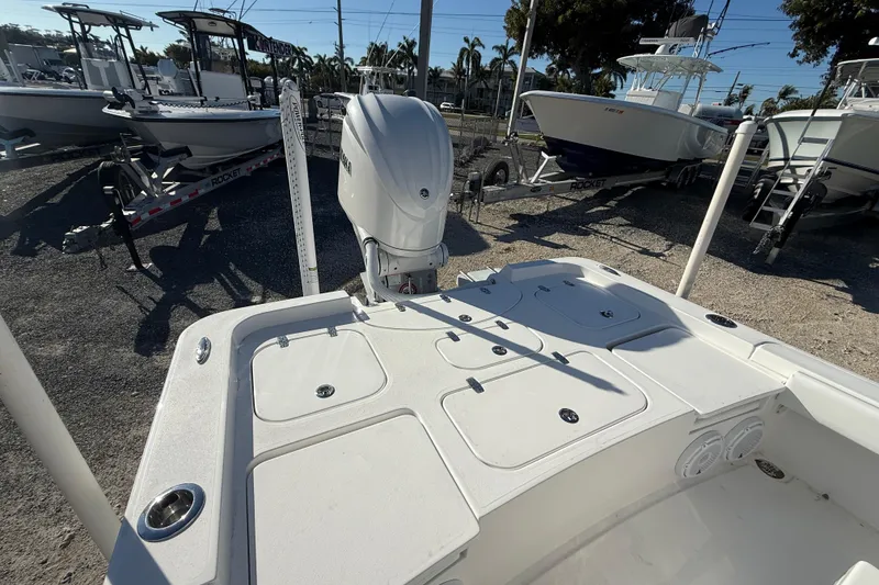 Slide: The Image of 2024 Contender 25 Bay boat with outboard motor, docked in a marina. - 9