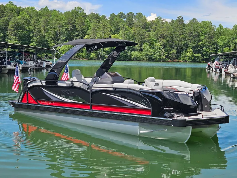The Image of 2026 JC SportToon 24 TT DSL pontoon boat on a serene lake. - 1