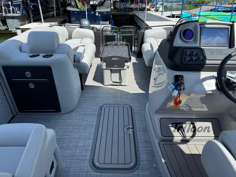 Slide: The Image of Interior of 2026 JC SportToon 24 TT DSL pontoon boat, featuring luxurious seating and modern controls. - 12