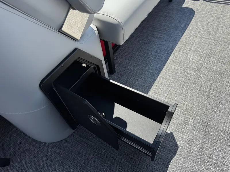 Slide: The Image of Open storage compartment on 2026 JC SportToon 24 TT DSL boat, featuring sleek design and gray upholstery. - 20