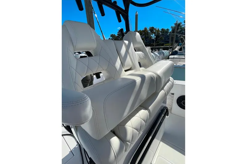 Slide: The Image of 2024 Onslow Bay 33 Tournament boat with luxurious white seating and sleek design. - 11