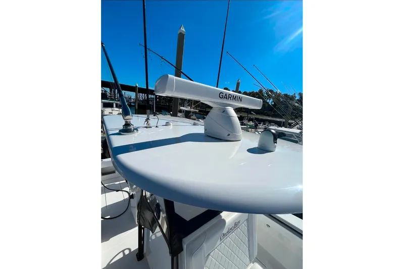 Slide: The Image of 2024 Onslow Bay 33 Tournament boat with Garmin radar, docked under clear blue sky. - 13