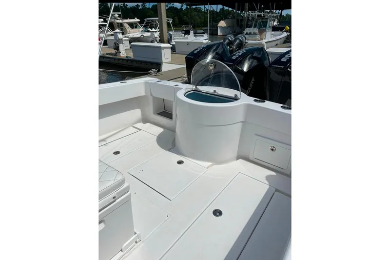 Slide: The Image of 2024 Onslow Bay 33 Tournament boat interior with seating and storage compartments. - 8