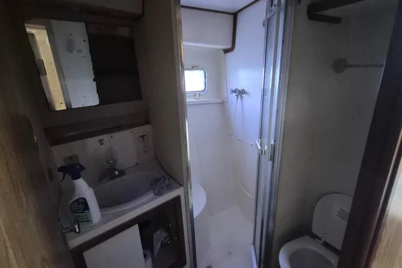 Slide: The Image of 1982 Bertram 38 Convertible bathroom with sink, shower, and toilet. - 21