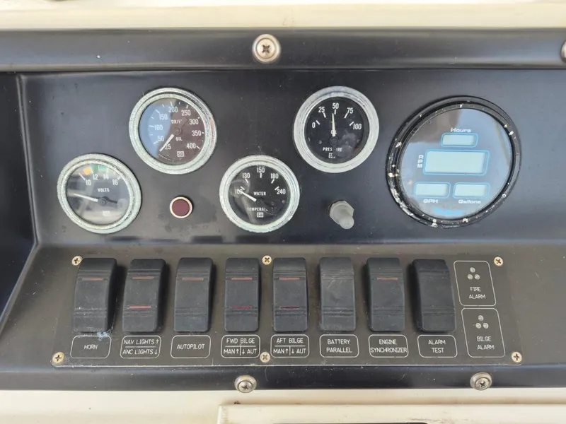 Slide: The Image of Control panel of a 1982 Bertram 38 Convertible boat with gauges and switches. - 30
