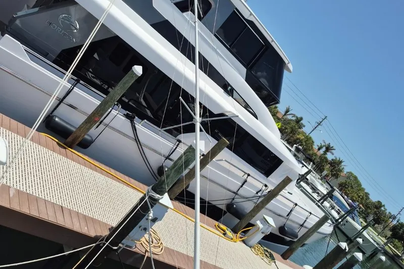 Slide: The Image of 1982 Bertram 38 Convertible yacht docked at a marina under clear blue skies. - 43