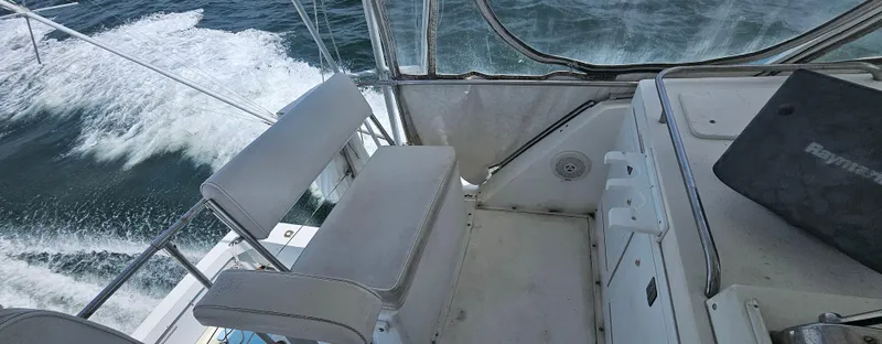 Slide: The Image of Cockpit view of a 1982 Bertram 38 Convertible boat cruising on the ocean. - 48