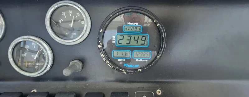 Slide: The Image of Dashboard gauges of a 1982 Bertram 38 Convertible boat, displaying engine hours and fuel data. - 49