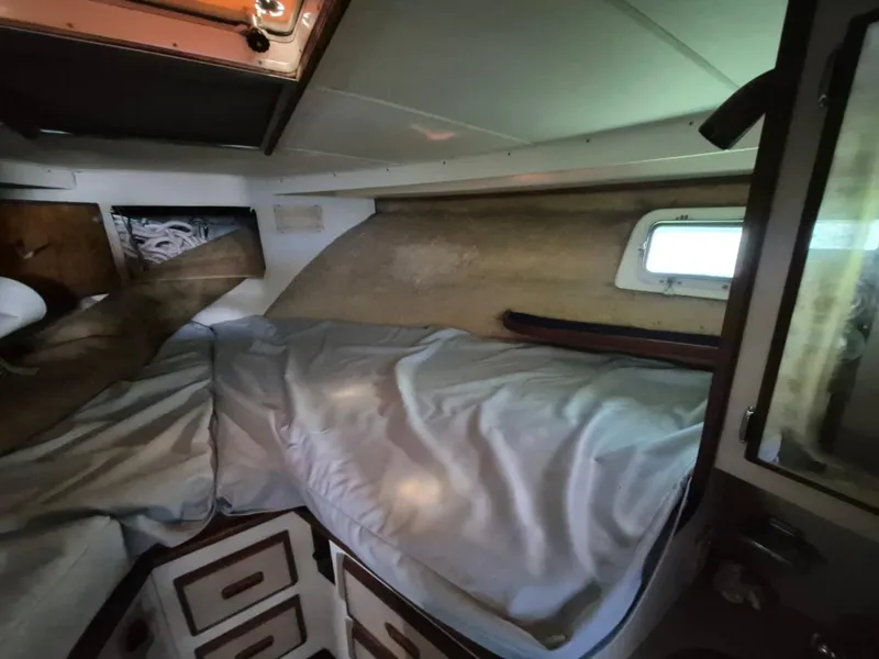 Slide: The Image of Cozy cabin interior of 1982 Bertram 38 Convertible boat with bed and window. - 20