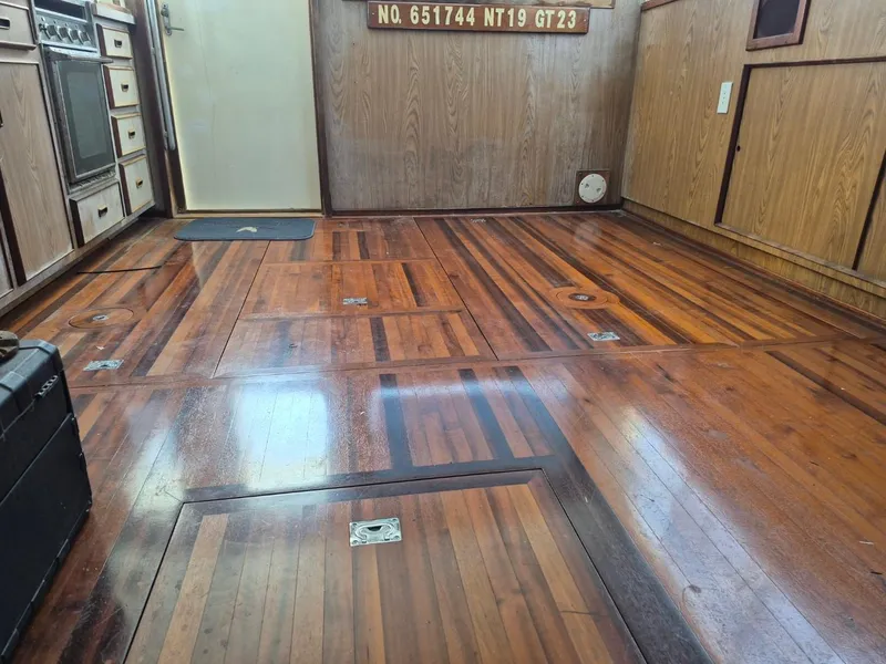Slide: The Image of Interior of a 1982 Bertram 38 Convertible with polished wooden flooring. - 16