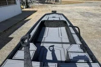 Slide: The Image of 2026 Gator Tail 1854 Extreme boat, gray interior, parked outdoors. - 10