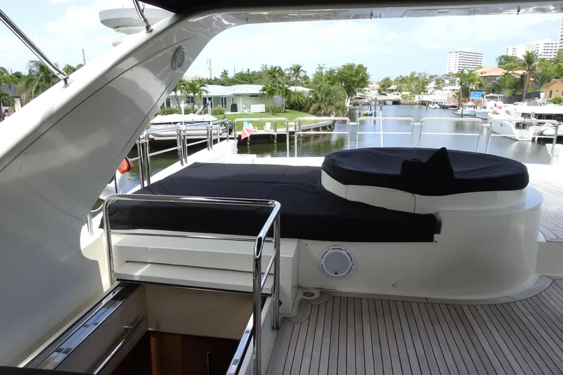 Slide: The Image of Luxurious seating area on 2010 Azimut 100 Leonardo yacht, featuring black cushions and sleek design. - 82