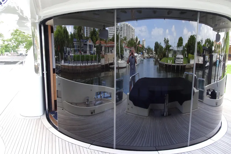 Slide: The Image of Side view of 2010 Azimut 100 Leonardo yacht docked by a calm waterfront. - 91