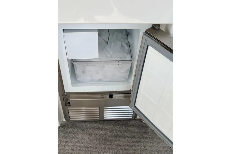 Slide: The Image of Ice maker inside 1997 Sea Ray 420 Aft Cabin yacht, filled with ice cubes. - 12