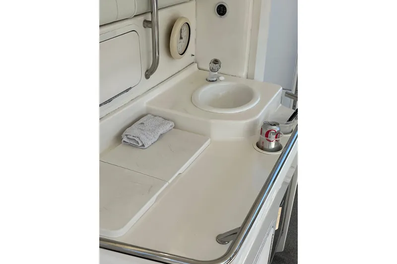 Slide: The Image of 1997 Sea Ray 420 Aft Cabin boat sink area with towel and drink can. - 13