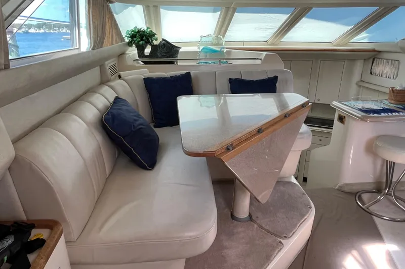 Slide: The Image of Luxurious interior of 1997 Sea Ray 420 Aft Cabin yacht with plush seating and elegant decor. - 23
